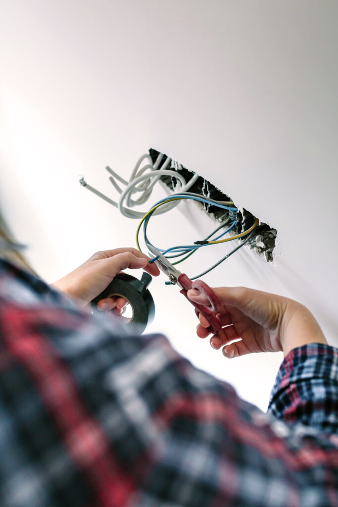 Unrecognizable electrician working on the electrical installation of a house